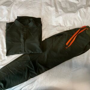 Figs scrub set in dark green with orange drawstring, size small